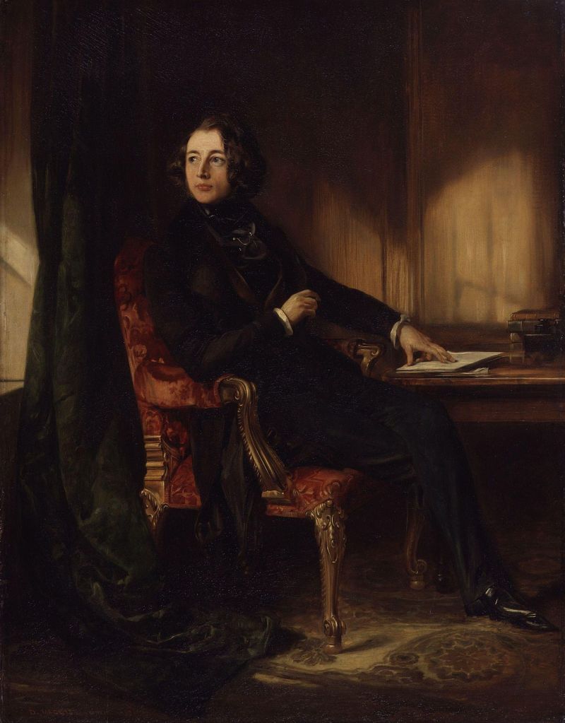 Daniel Maclise's oil painting titled, Portrait of Charles Dickens, where Dickens is sitting on a chair and reflecting. 