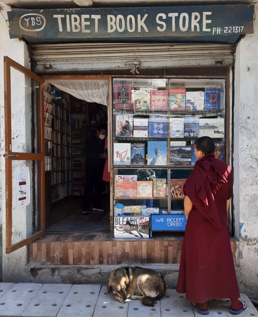 A monk standing outside a bookshop in Mcleodganj
