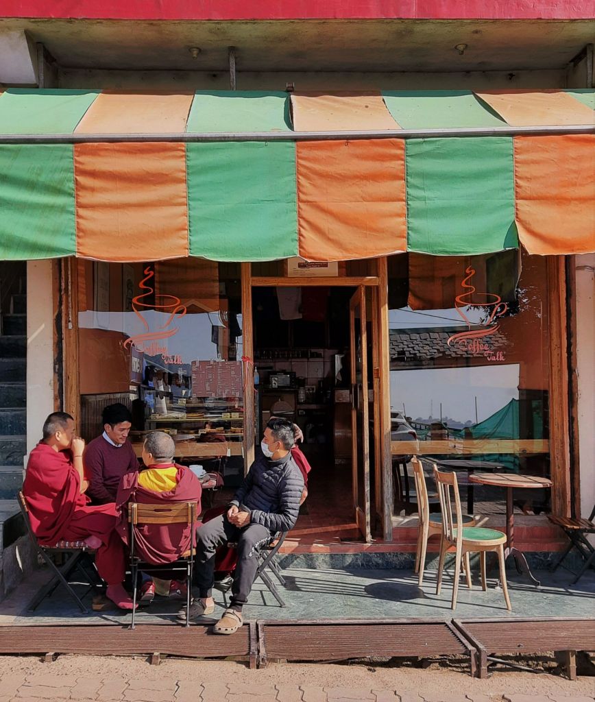 Buddhist monks having a conversation at a cafe