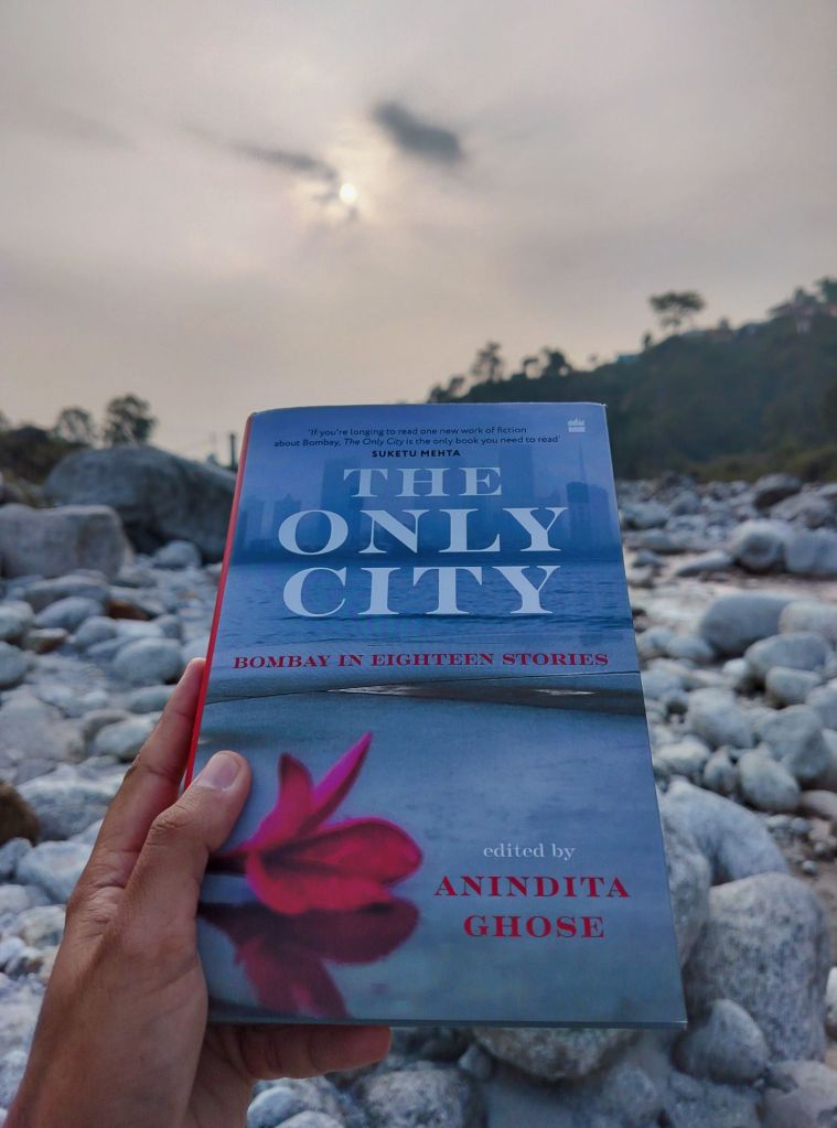The Only City Bombay in Eighteen Stories book held with a river in background
