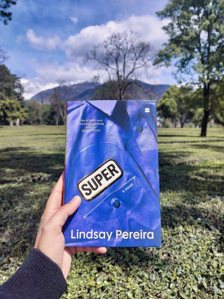 Holding Lindsay Pereira's book Super against a mountain backdrop